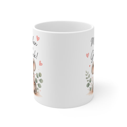 Rundum bedruckte Keramiktasse mit seitlich sichtbarem Koala-Motiv, Geschenkpaket und kleinen Herzillustrationen