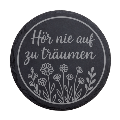 Runder schwarzer Schiefer-Untersetzer mit Schriftzug „Hör nie auf zu träumen“ und floraler Illustration