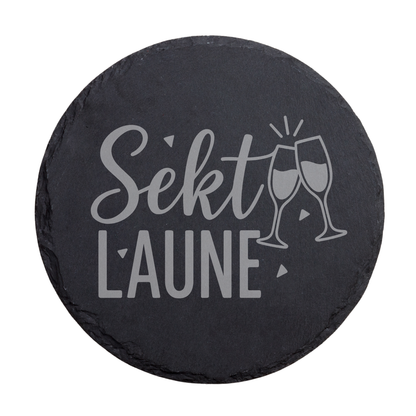 Runder schwarzer Schiefer-Untersetzer mit Schriftzug „Sektlaune“ und Sektglas Motiv
