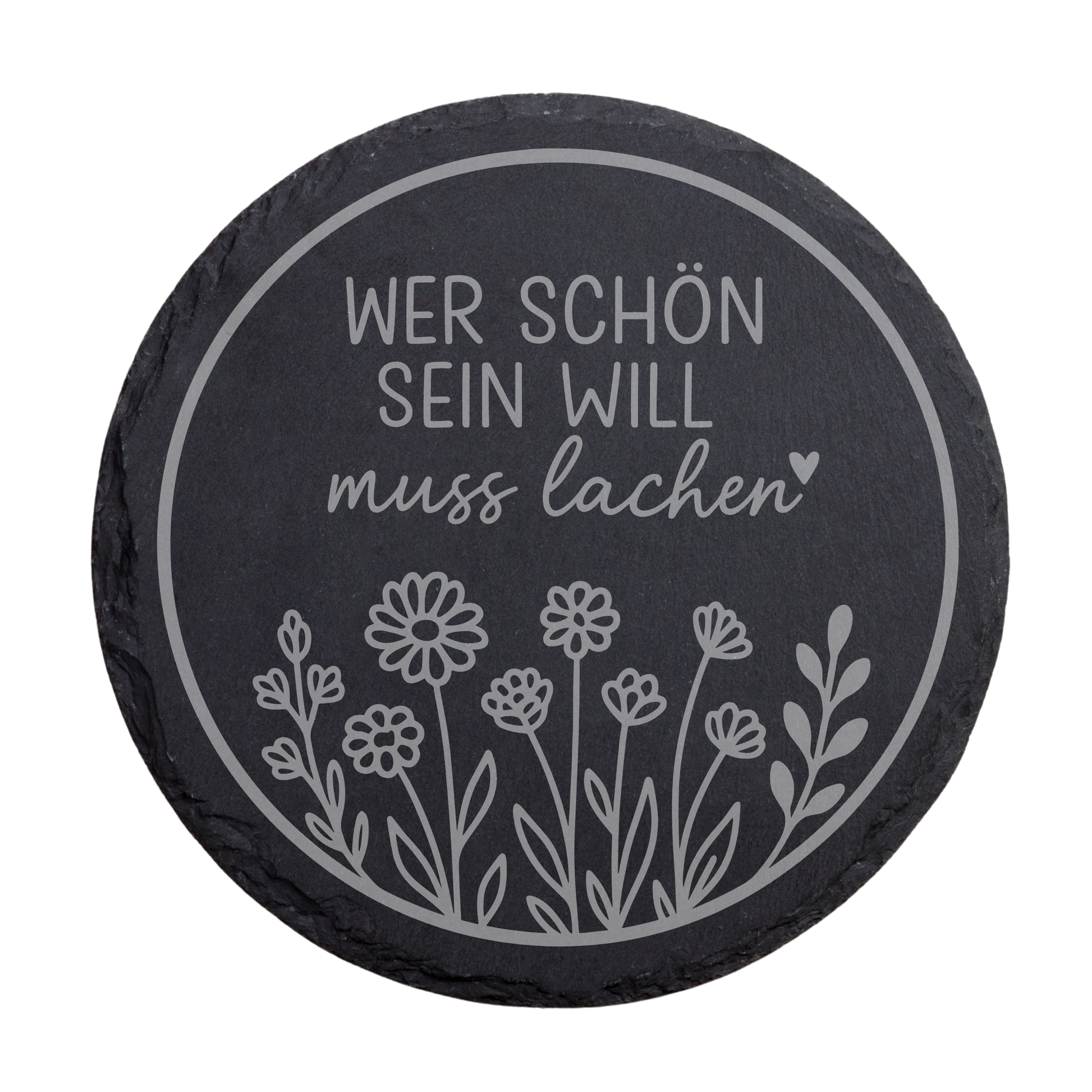 Runder schwarzer Schiefer-Untersetzer mit lustigem Spruch „Wer schön sein will muss lachen“ und floraler Illustration
